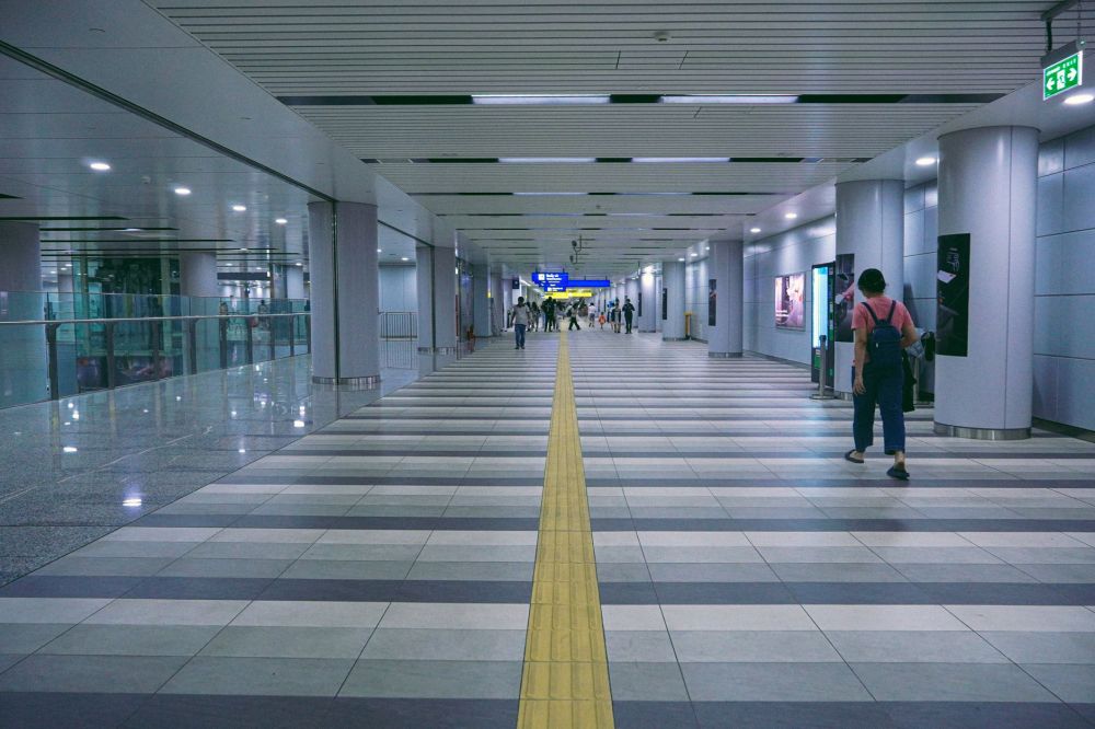 Bayfront MRT station concourse showing curved columns and public art installations underground