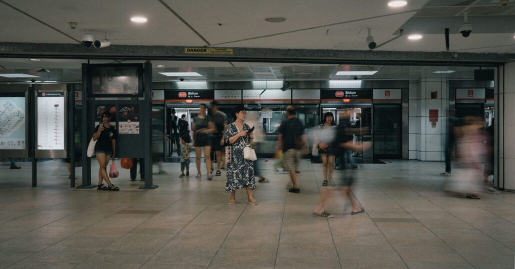 Commuters inside a Singapore MRT train carriage on a busy weekday morning