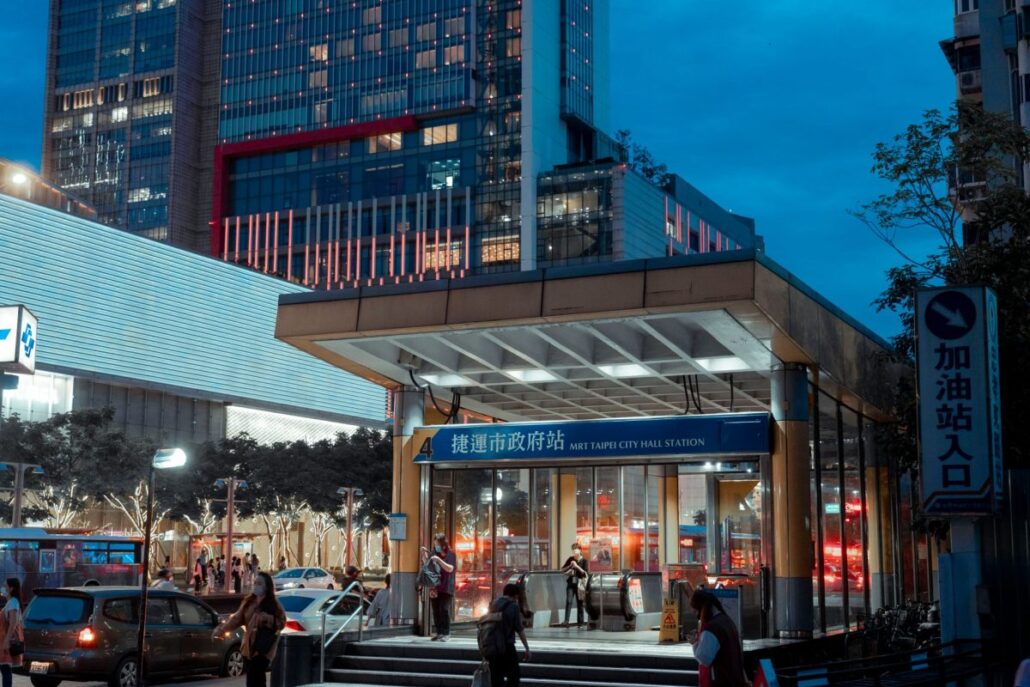 Commuters walking past a Singapore MRT station entrance near Labrador Park MRT