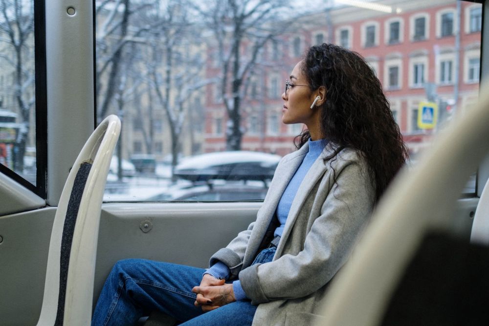 Commuter listening to audio content on public transport during their daily journey