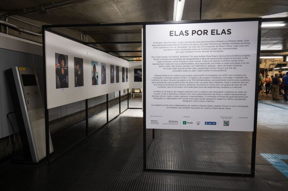 Visitors looking at posters and illustrations pinned on a public community display board